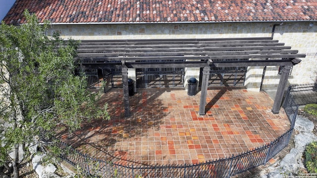 exterior view of a tiled roof, fence, and a gate