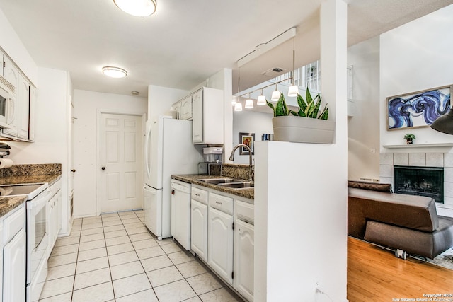 7930 Roanoke Unit 106, San Antonio, TX 78240 - kitchen with a sink, white appliances, white cabinets, and light tile patterned flooring