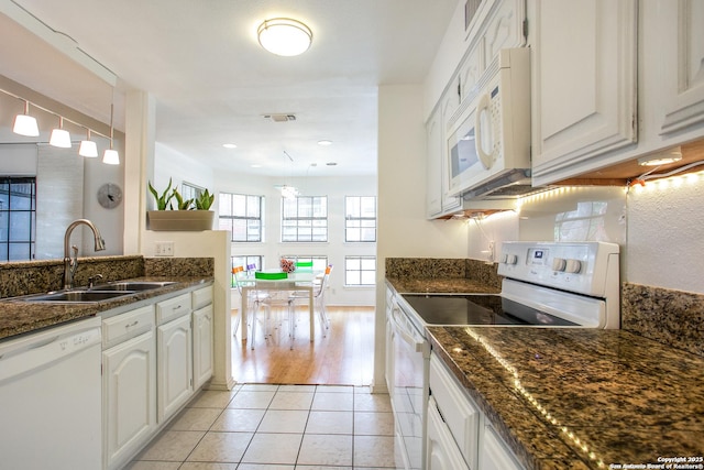 7930 Roanoke Unit 106, San Antonio, TX 78240 - kitchen featuring white appliances, a sink, light tile patterned floors, and decorative light fixtures