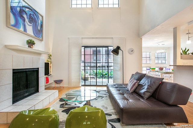 7930 Roanoke Unit 106, San Antonio, TX 78240 - living room with a towering ceiling, wood finished floors, and a fireplace