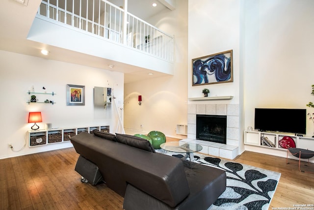 7930 Roanoke Unit 106, San Antonio, TX 78240 - living area with wood finished floors, a fireplace, a high ceiling, and recessed lighting