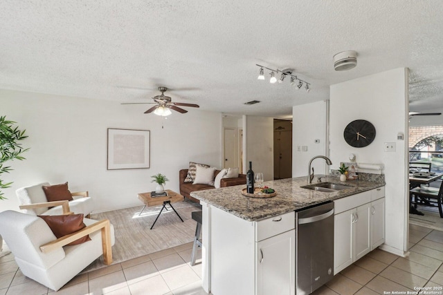 11731 Spring Rain, San Antonio, TX 78249 - kitchen with a sink, a ceiling fan, stainless steel dishwasher, a peninsula, and light tile patterned floors