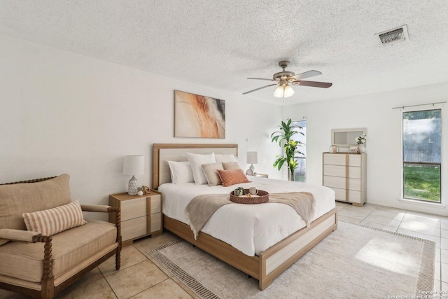 11731 Spring Rain, San Antonio, TX 78249 - bedroom with light tile patterned floors, a textured ceiling, and ceiling fan