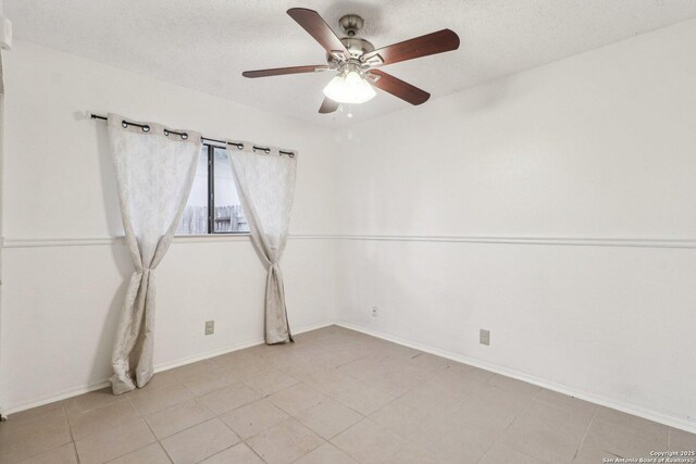 11731 Spring Rain, San Antonio, TX 78249 - unfurnished room with a ceiling fan, a textured ceiling, baseboards, and light tile patterned flooring