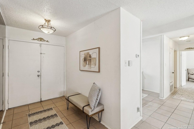 11731 Spring Rain, San Antonio, TX 78249 - foyer featuring a textured ceiling and light tile patterned floors