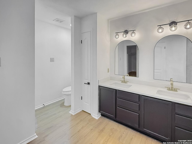 15827 Marisa, San Antonio, TX 78247 - full bath with double vanity, wood finished floors, baseboards, and toilet
