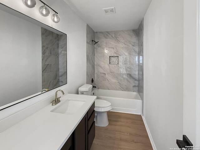 15827 Marisa, San Antonio, TX 78247 - bathroom featuring toilet, vanity, wood finished floors, and washtub / shower combination