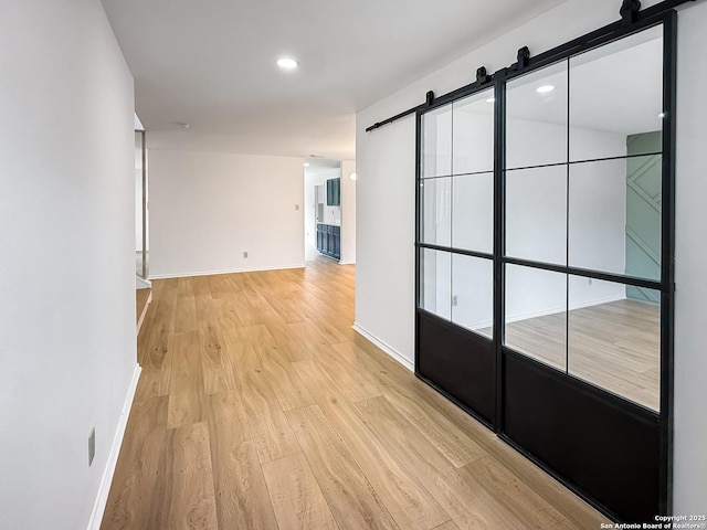 15827 Marisa, San Antonio, TX 78247 - hallway with a barn door, light wood-style floors, baseboards, and recessed lighting