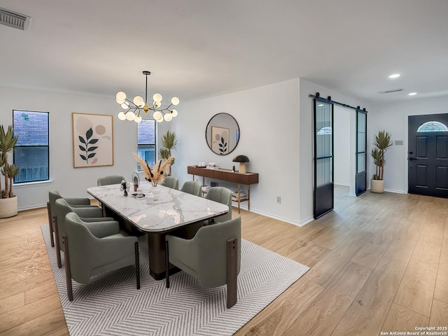 15827 Marisa, San Antonio, TX 78247 - dining area featuring a barn door, a chandelier, light wood-style floors, recessed lighting, and baseboards