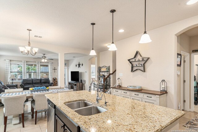 12338 Belfort Pt, Schertz, TX 78154 - kitchen with a sink, arched walkways, light tile patterned floors, open floor plan, and recessed lighting