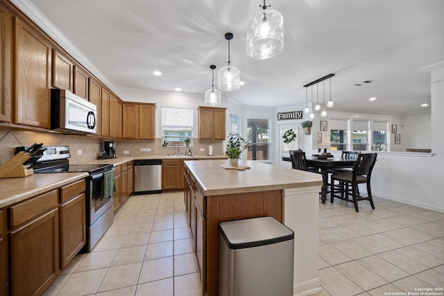kitchen with stainless steel appliances, light tile patterned floors, a sink, backsplash, and crown molding