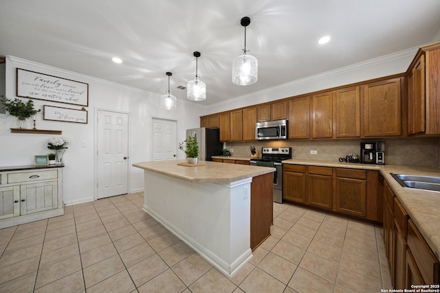 kitchen featuring appliances with stainless steel finishes, brown cabinets, a kitchen island, light tile patterned floors, and ornamental molding