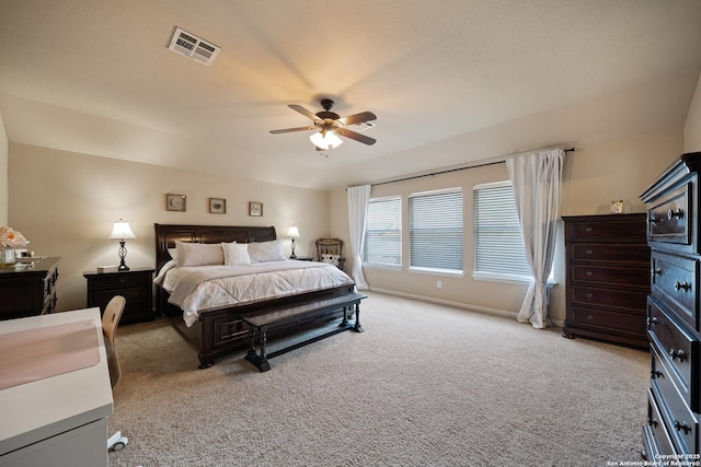 bedroom featuring light colored carpet and a ceiling fan