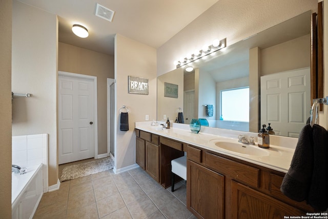 bathroom featuring a garden tub, double vanity, tile patterned floors, a stall shower, and baseboards