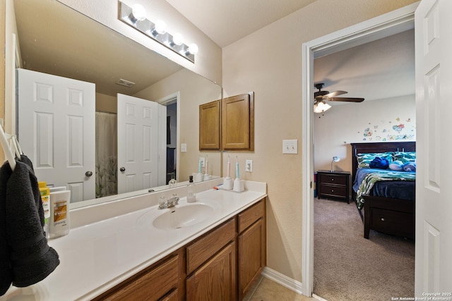 ensuite bathroom featuring vanity, a ceiling fan, and a shower with shower curtain