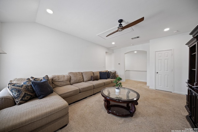 living area featuring a ceiling fan, light carpet, recessed lighting, arched walkways, and attic access