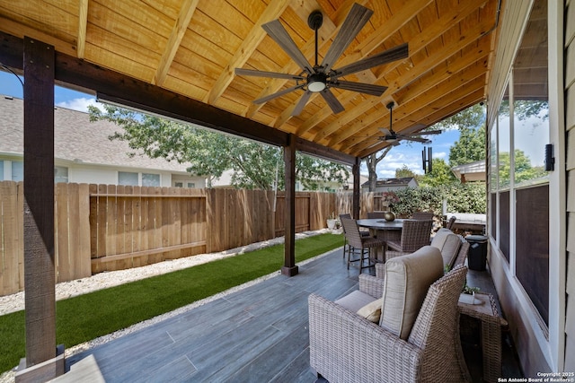 view of patio with ceiling fan, outdoor dining area, and a deck