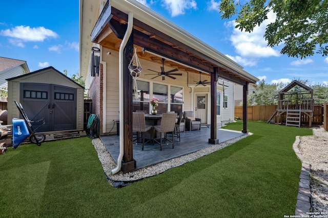 view of patio with a ceiling fan, a storage unit, a playground, and an outdoor structure