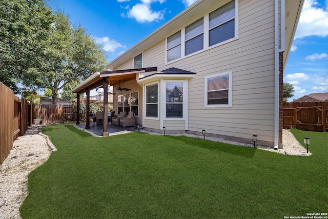 rear view of property with ceiling fan, a patio area, and an outdoor living space
