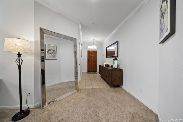 hall with carpet floors, crown molding, and baseboards