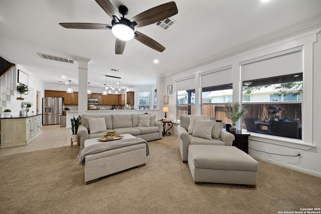 living room featuring a ceiling fan, light colored carpet, recessed lighting, and ornamental molding
