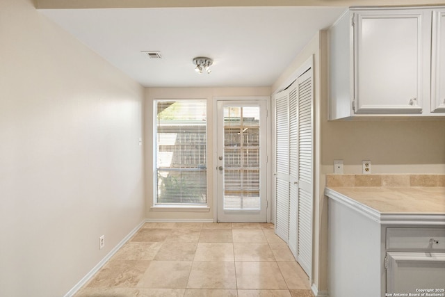 3678 Hidden Unit 504, San Antonio, TX 78217 - doorway to outside featuring baseboards and light tile patterned floors