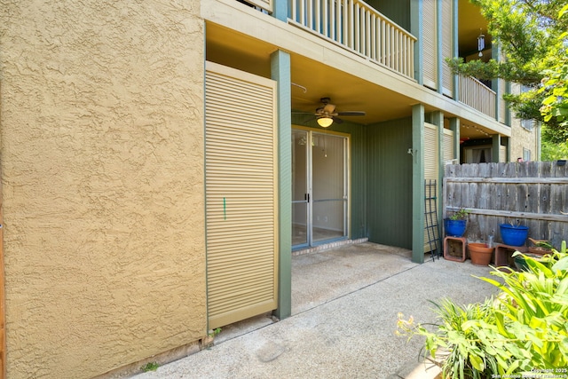 3678 Hidden Unit 504, San Antonio, TX 78217 - view of exterior entry featuring stucco siding, fence, a ceiling fan, and a patio