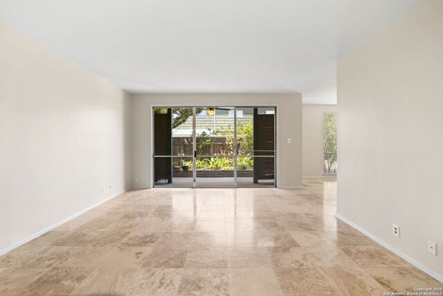 3678 Hidden Unit 504, San Antonio, TX 78217 - empty room featuring baseboards and light stone finish floors