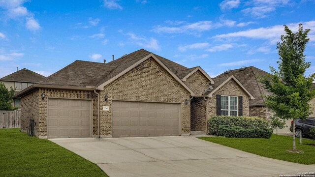 12243 Dusty Boots, San Antonio, TX 78254 - view of front facade with a garage, concrete driveway, brick siding, and roof with shingles