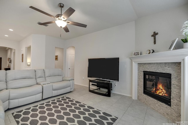 12243 Dusty Boots, San Antonio, TX 78254 - living area with arched walkways, a ceiling fan, light tile patterned floors, a glass covered fireplace, and recessed lighting