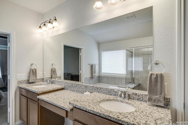 12243 Dusty Boots, San Antonio, TX 78254 - full bath featuring double vanity, a bath, a shower stall, vaulted ceiling, and connected bathroom