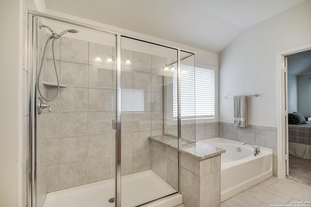 12243 Dusty Boots, San Antonio, TX 78254 - full bath with lofted ceiling, a bath, ensuite bath, a stall shower, and tile patterned flooring