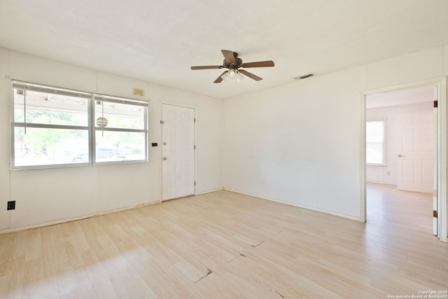 spare room featuring ceiling fan, wood finished floors, and baseboards