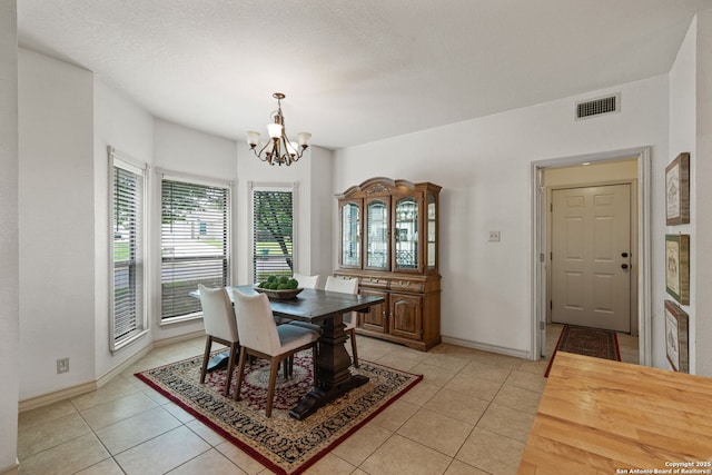 107 River Knl, Castroville, TX 78009 - dining room with a chandelier, light tile patterned flooring, and baseboards