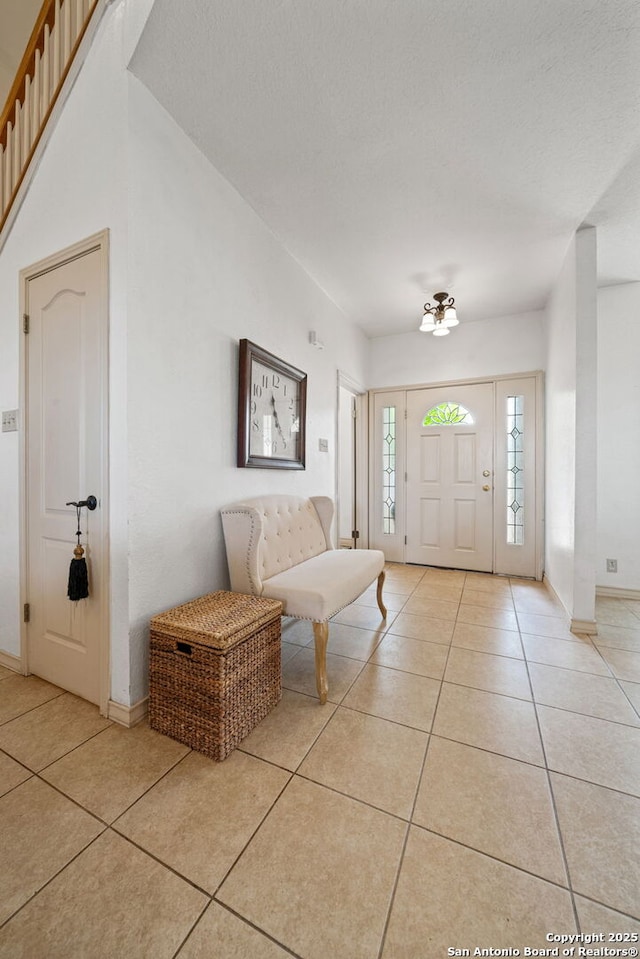 107 River Knl, Castroville, TX 78009 - entrance foyer with light tile patterned flooring, baseboards, and a textured ceiling