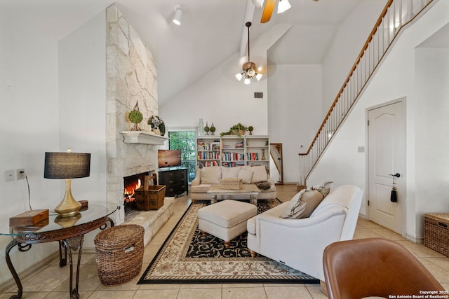 107 River Knl, Castroville, TX 78009 - living room with high vaulted ceiling, stairs, ceiling fan, tile patterned floors, and a fireplace