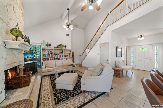 107 River Knl, Castroville, TX 78009 - living area featuring stairway, high vaulted ceiling, beam ceiling, tile patterned flooring, and plenty of natural light