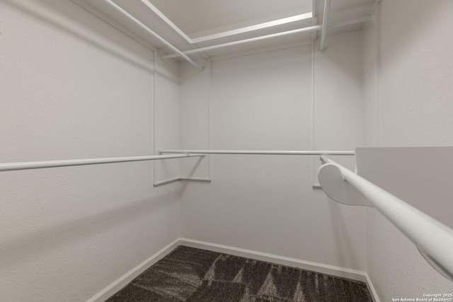 107 Mesa Del Sol, Kerrville, TX 78028 - walk in closet featuring dark carpet