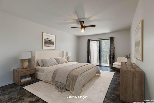 107 Mesa Del Sol, Kerrville, TX 78028 - bedroom featuring access to outside, dark stone finish floors, a ceiling fan, and baseboards
