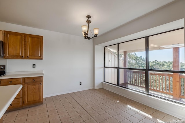 107 Mesa Del Sol, Kerrville, TX 78028 - unfurnished dining area featuring plenty of natural light, a chandelier, light tile patterned floors, and baseboards