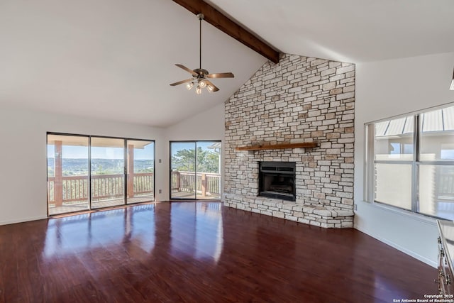 107 Mesa Del Sol, Kerrville, TX 78028 - unfurnished living room with ceiling fan, wood finished floors, beam ceiling, a fireplace, and baseboards