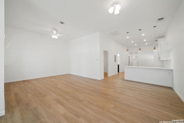 1212 Morales, San Antonio, TX 78207 - unfurnished living room featuring ceiling fan, light wood-style flooring, recessed lighting, and baseboards