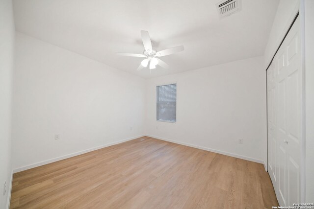 1212 Morales, San Antonio, TX 78207 - unfurnished bedroom featuring light wood-type flooring, a closet, baseboards, and a ceiling fan