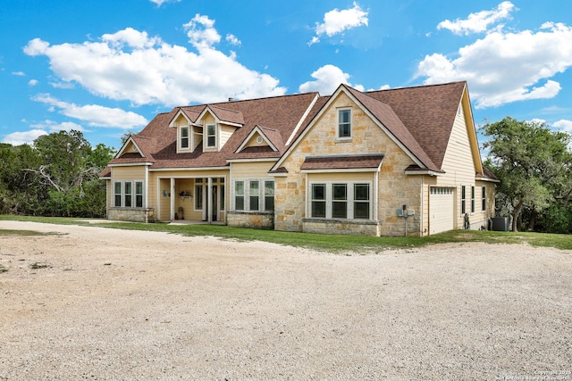 201 Oak Rdg, Boerne, TX 78006 - view of front of home with stone siding, an attached garage, roof with shingles, and central AC