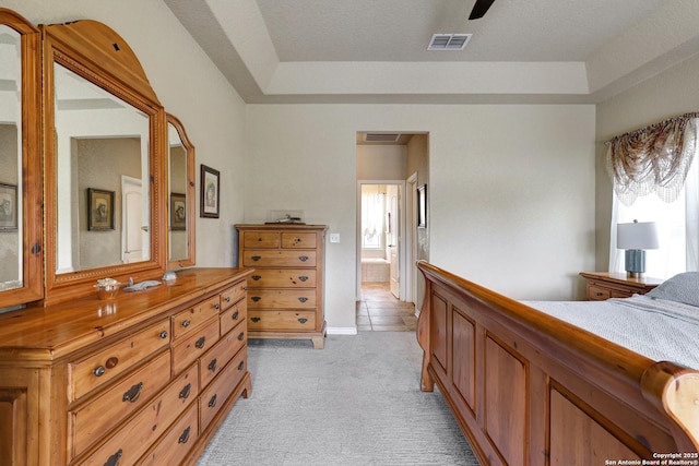 201 Oak Rdg, Boerne, TX 78006 - bedroom featuring light colored carpet, a raised ceiling, and connected bathroom