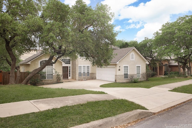 18127 Brookwood Frst, San Antonio, TX 78258 - view of front facade featuring concrete driveway, stucco siding, and stone siding