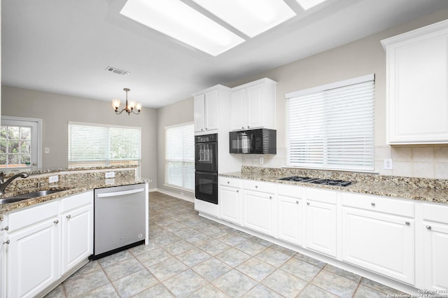 18127 Brookwood Frst, San Antonio, TX 78258 - kitchen featuring black appliances, a chandelier, a sink, and white cabinets