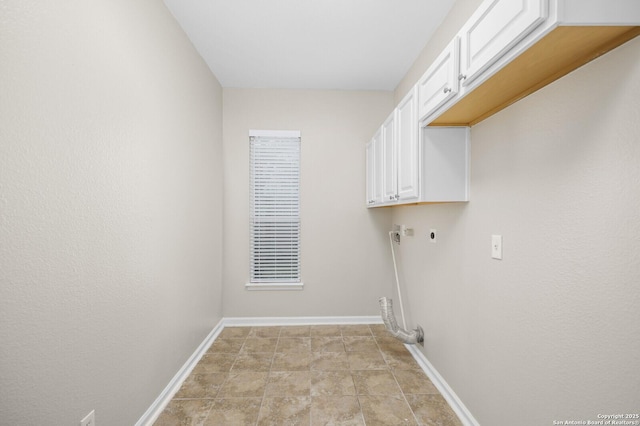 18127 Brookwood Frst, San Antonio, TX 78258 - laundry area featuring cabinet space, hookup for an electric dryer, and baseboards