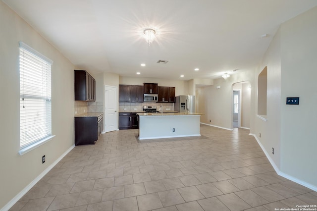 173 Kildeer Crk, San Antonio, TX 78253 - kitchen with appliances with stainless steel finishes, tasteful backsplash, arched walkways, plenty of natural light, and recessed lighting