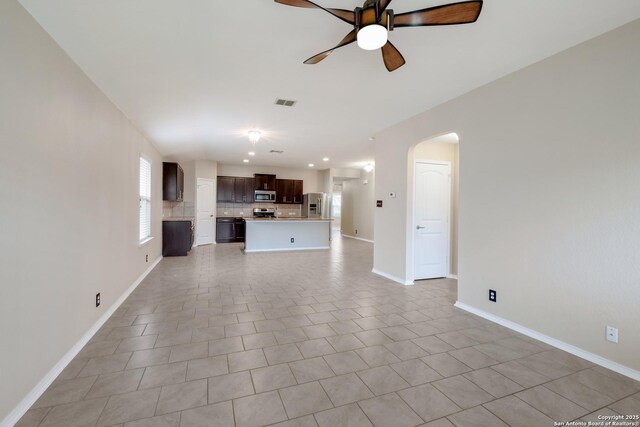 173 Kildeer Crk, San Antonio, TX 78253 - unfurnished living room featuring a ceiling fan, arched walkways, and baseboards